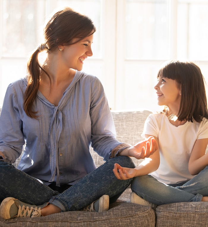 Mother and young daughter meditating